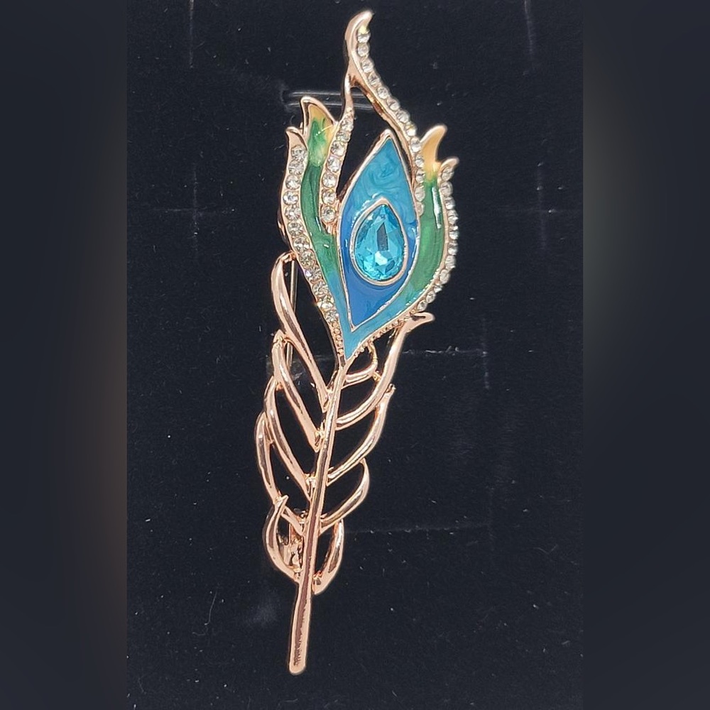 Gold based peacock feather brooch